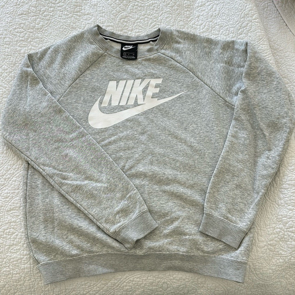 Heather grey woman’s crew neck Nike sweatshirt with white logo. Size S